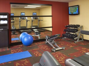 A gym with treadmills, dumbbells, exercise balls, and a weight bench. - Courtyard by Marriott Lexington North (Lexington)