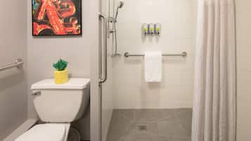 A bathroom with a toilet, a shower, and a towel rack.