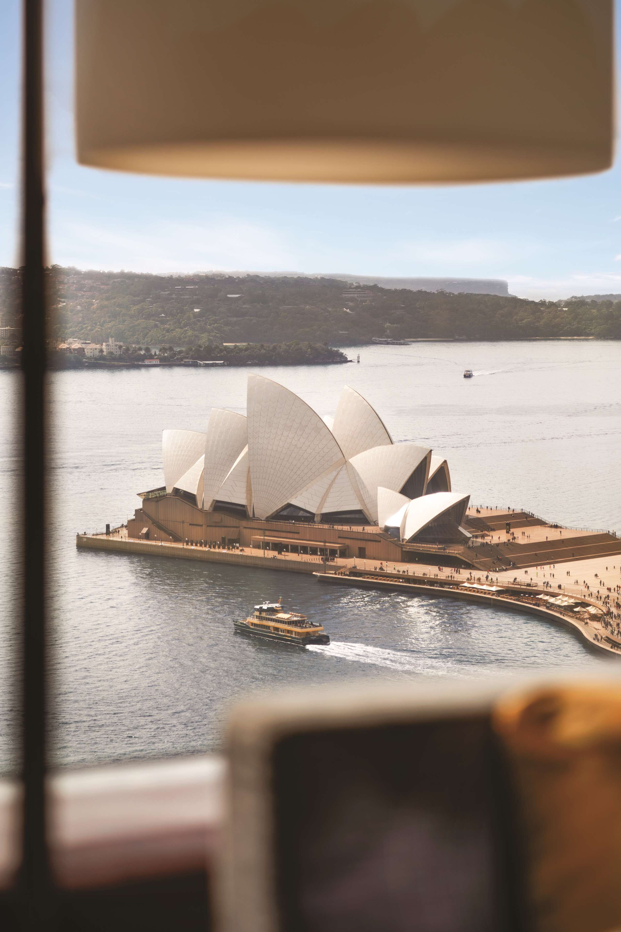 A view of the Sydney Opera House with the Sydney Harbour Bridge in the background.
