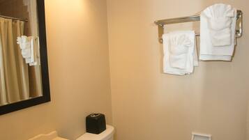 A bathroom with a sink, mirror, and towel rack.