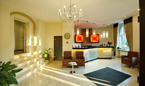 A hotel lobby with a reception desk, seating area, and a chandelier. - Best Western Hotel Kaiserhof (Bonn)