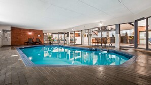 Relax by the pool surrounded by comfortable lounge chairs and tables.