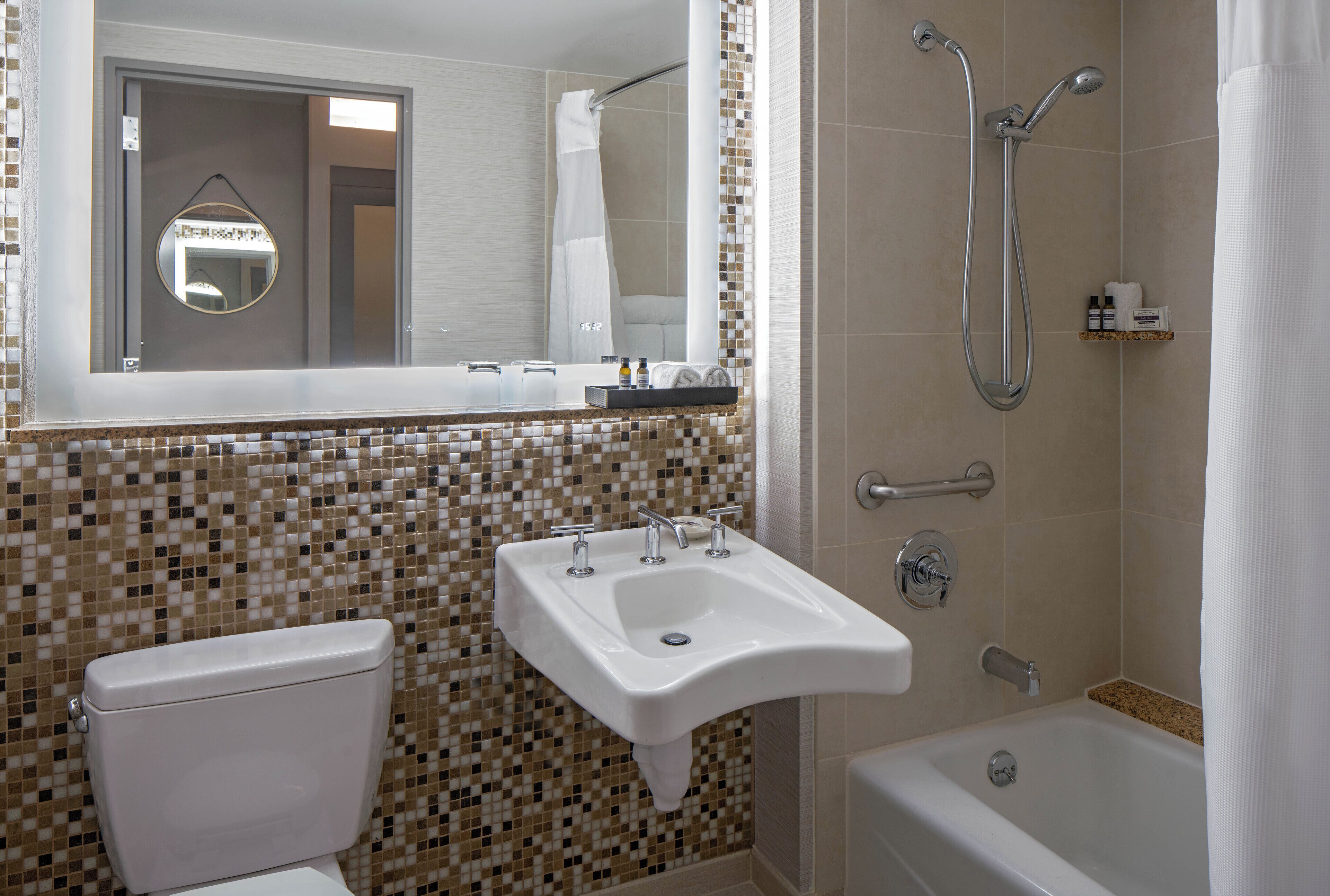 A bathroom with a toilet, sink, and bathtub.