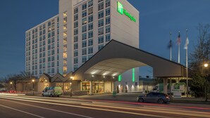 A Holiday Inn hotel with a modern design, featuring a large entrance canopy and multiple floors. - Holiday Inn Portland-By the Bay by IHG (Portland)