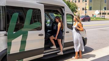 A white van with green stripes parked on the side of a road.