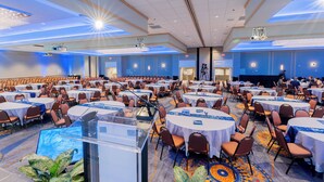 A large conference room with round tables, chairs, and a podium. - Holiday Inn Portland-By the Bay by IHG (Portland)
