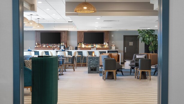 A modern bar area with seating and a bar counter. - Holiday Inn Portland-By the Bay by IHG (Portland)