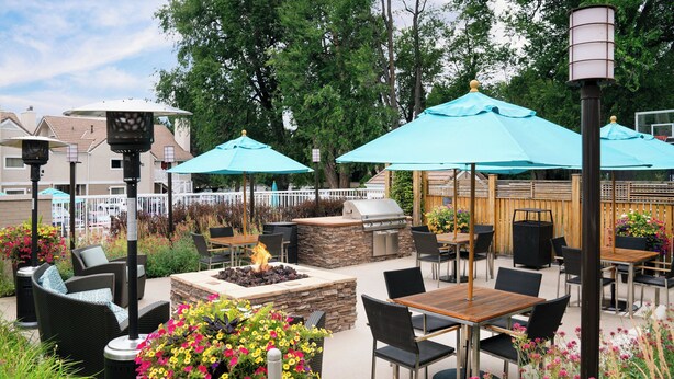 An outdoor patio with seating, a fire pit, and umbrellas. - Residence Inn By Marriott Boulder (Boulder)