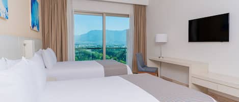 A hotel room with two beds, a TV, a desk, and a chair.