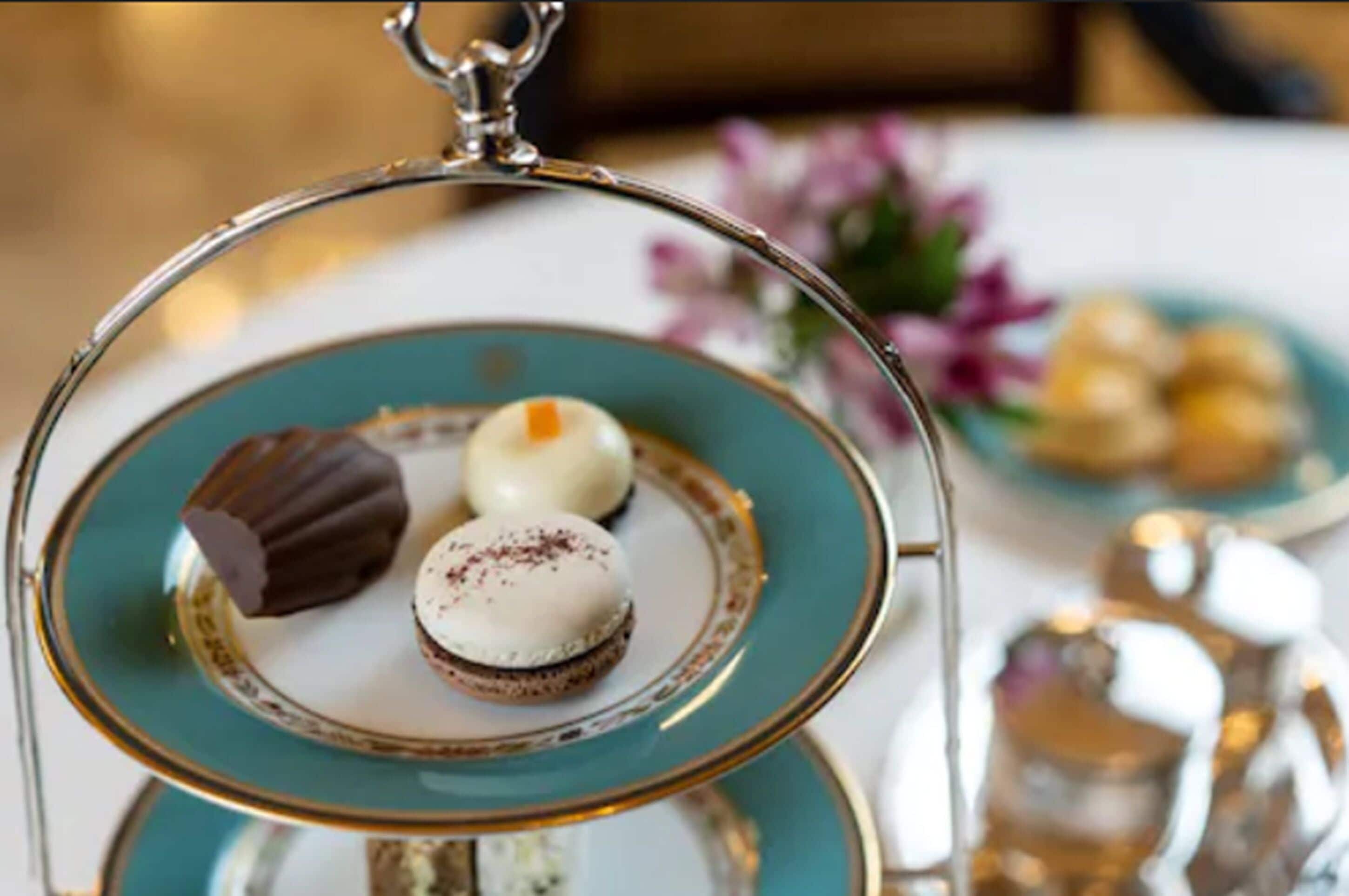 A dessert tray with three different types of desserts on a teal plate.