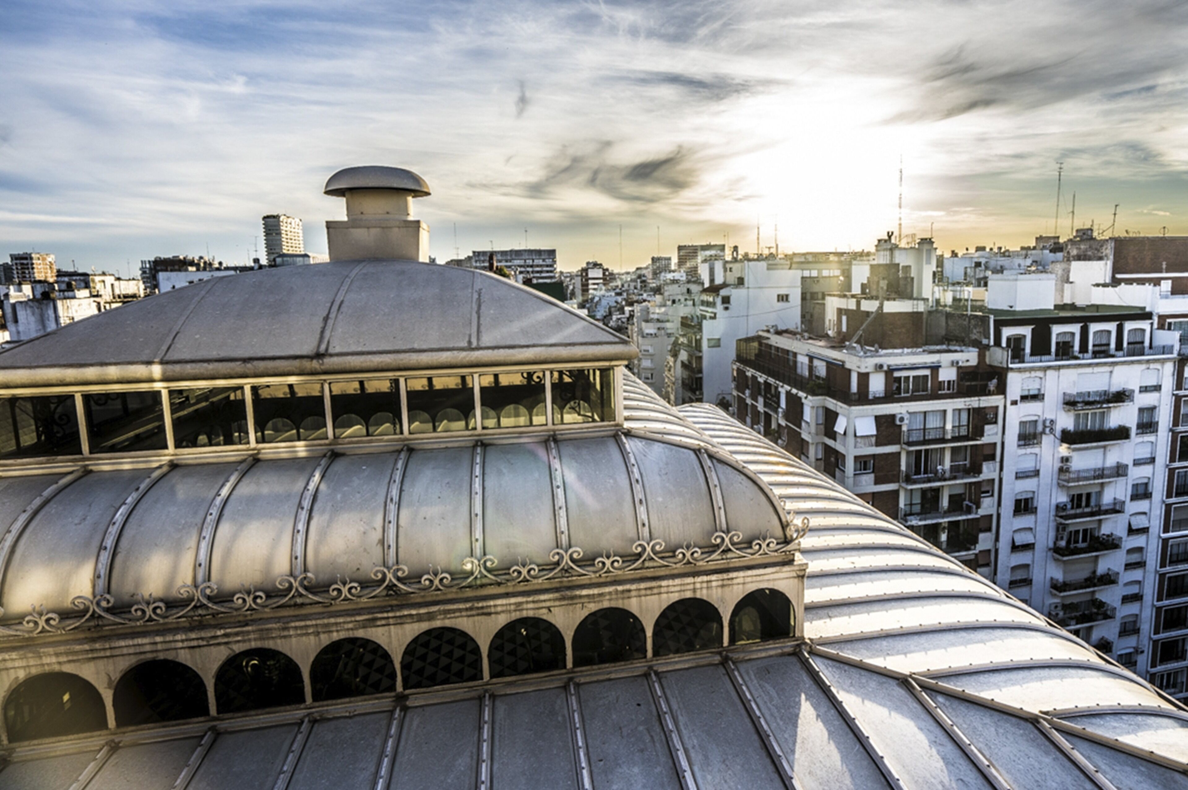 A high-rise building with a domed roof and multiple balconies.