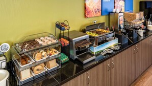 A breakfast buffet with various food items and a coffee station. - Comfort Inn Winnipeg Airport (Winnipeg)