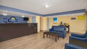 A reception area with a reception desk, a blue sofa, and a coffee station.