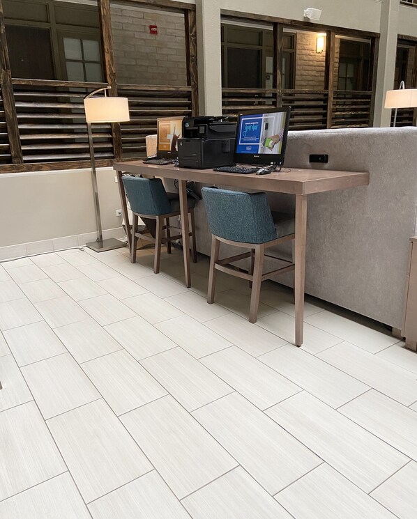 A modern workspace with two desks, chairs, and a computer setup.