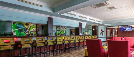 A bar area with multiple chairs and a counter.