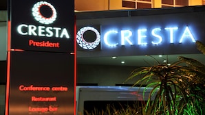 A hotel sign with the name "CRESTA" and mentions a conference center, restaurant, and lounge bar. - Cresta President (Gaborone)