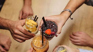 A group of people holding drinks in a circle.
