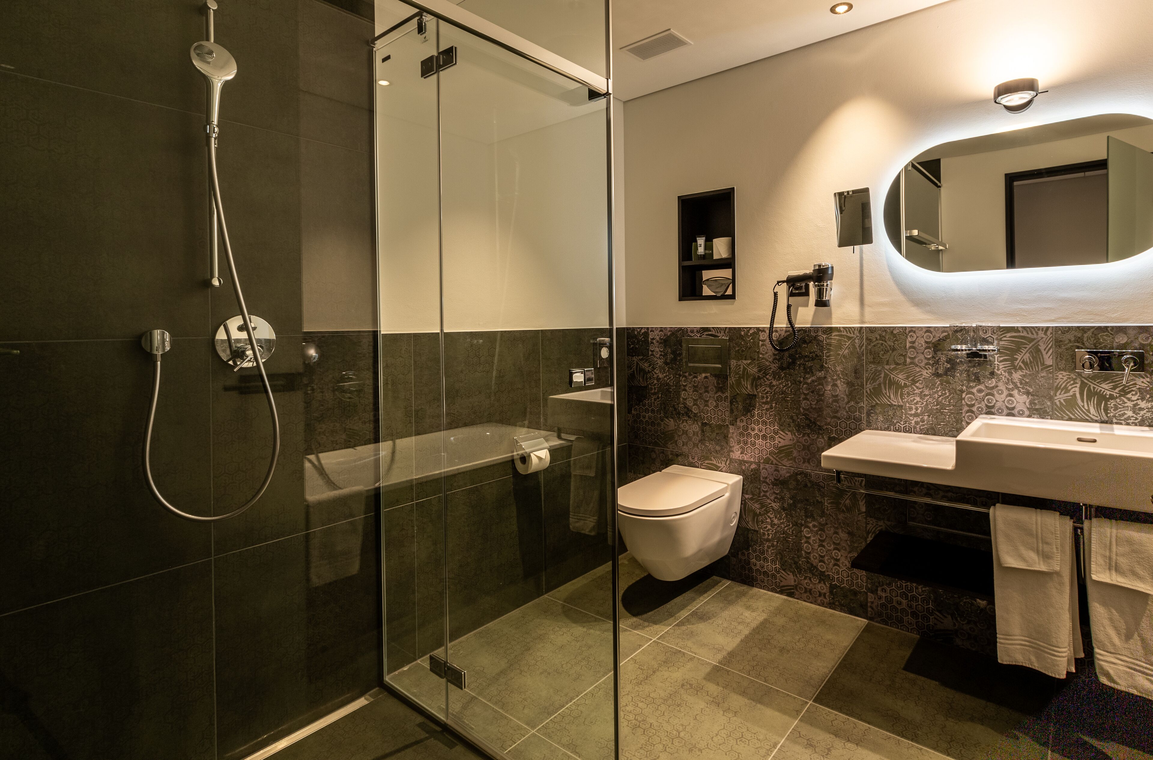 boutique deluxe-jungfrau view | bathroom | hair dryer, slippers, towels, soap