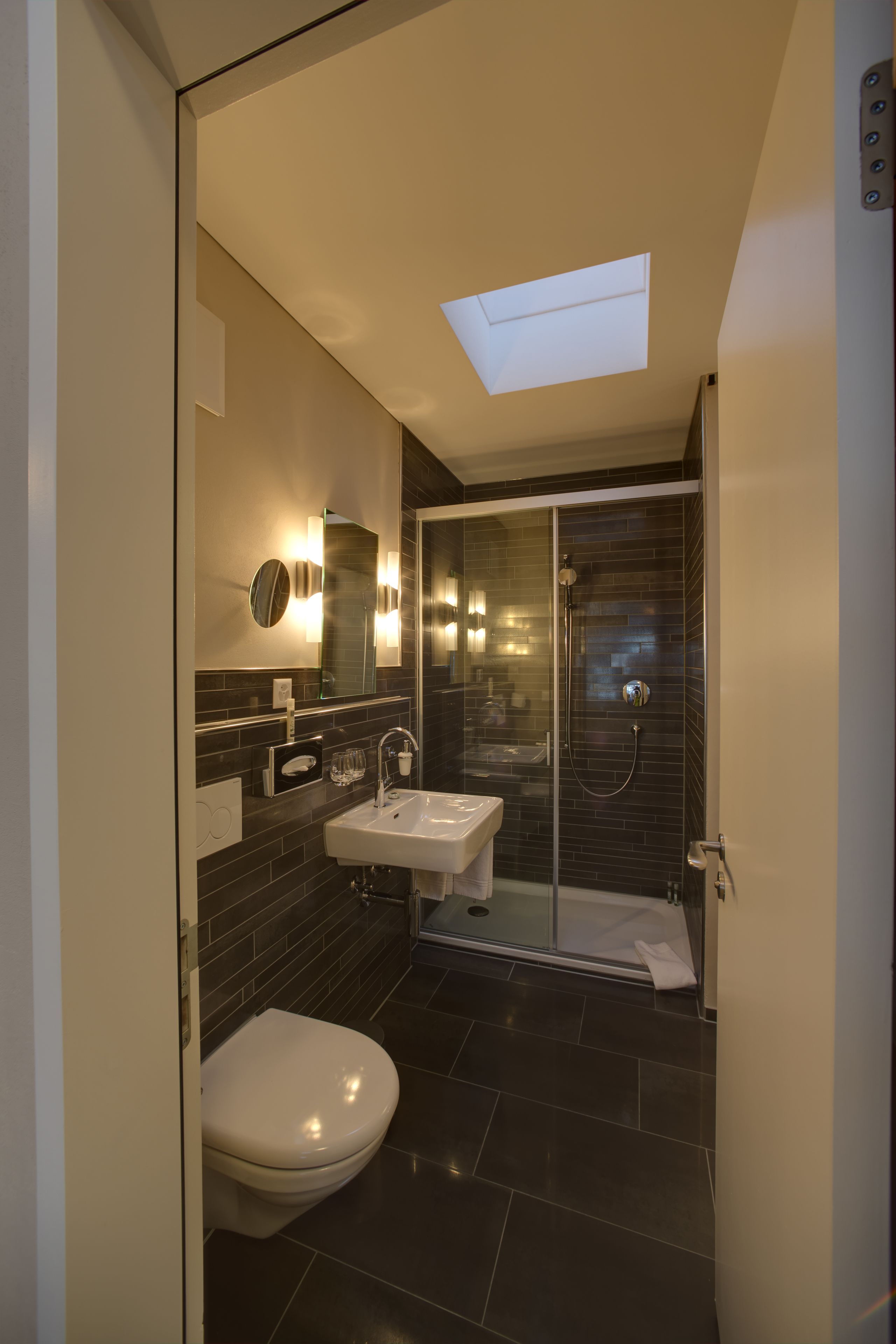 bellevue apartment | bathroom | hair dryer, slippers, towels, soap