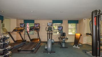 A gym with treadmills, elliptical machines, and weight equipment.