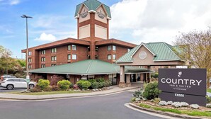 A Country Inn & Suites by Radisson building with a prominent tower, a covered entrance, and a signboard. - Country Inn & Suites by Radisson, Atlanta Galleria/Ballpark, GA (Atlanta)