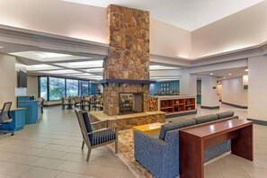 A spacious lobby with a stone fireplace, seating areas, and a reception desk. - Country Inn & Suites by Radisson, Atlanta Galleria/Ballpark, GA (Atlanta)