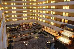 A multi-level hotel atrium with numerous balconies, a central courtyard with seating, and a water feature. - DoubleTree by Hilton Fresno Convention Center (Fresno)