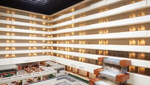 A multi-level atrium with a central water feature, multiple floors with uniformly lit rooms, and a spacious seating area with tables and chairs. - DoubleTree by Hilton Fresno Convention Center (Fresno)
