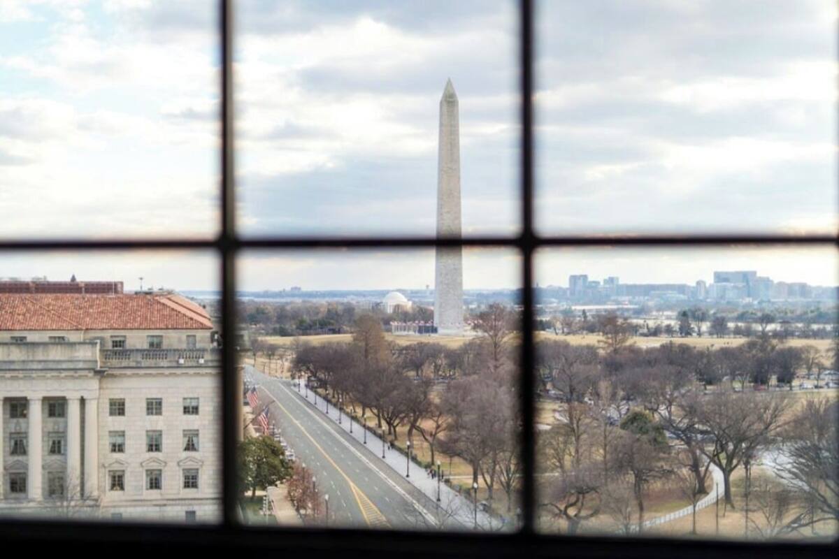 A view of the Washington Monument through a window with a grid pattern.