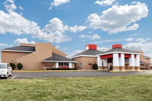 A building with a parking lot and a grassy area in front. -  Econo Lodge Wausau - Rothschild (Rothschild)