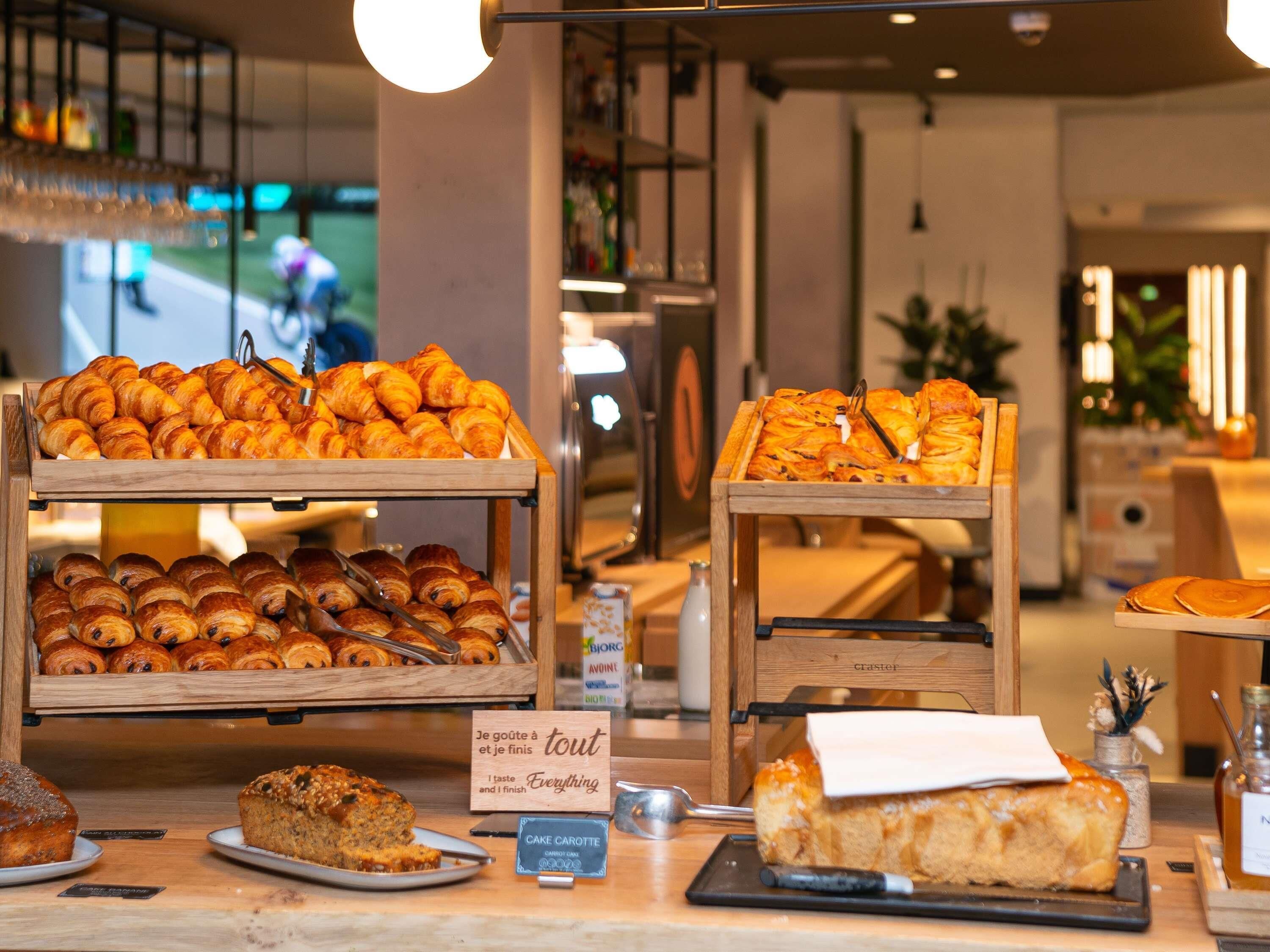 A bakery display with various pastries and a sign indicating a taste for everything.