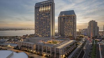 A high-rise building complex with multiple floors, large windows, and a waterfront view.