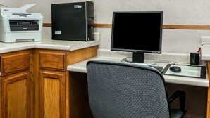 A home office setup with a desktop computer, a printer, and a framed picture on the wall. - Econo Lodge & Suites Grand Rapids Airport (Grand Rapids)