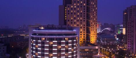 A high-rise hotel with a modern design, featuring a prominent Hilton logo.