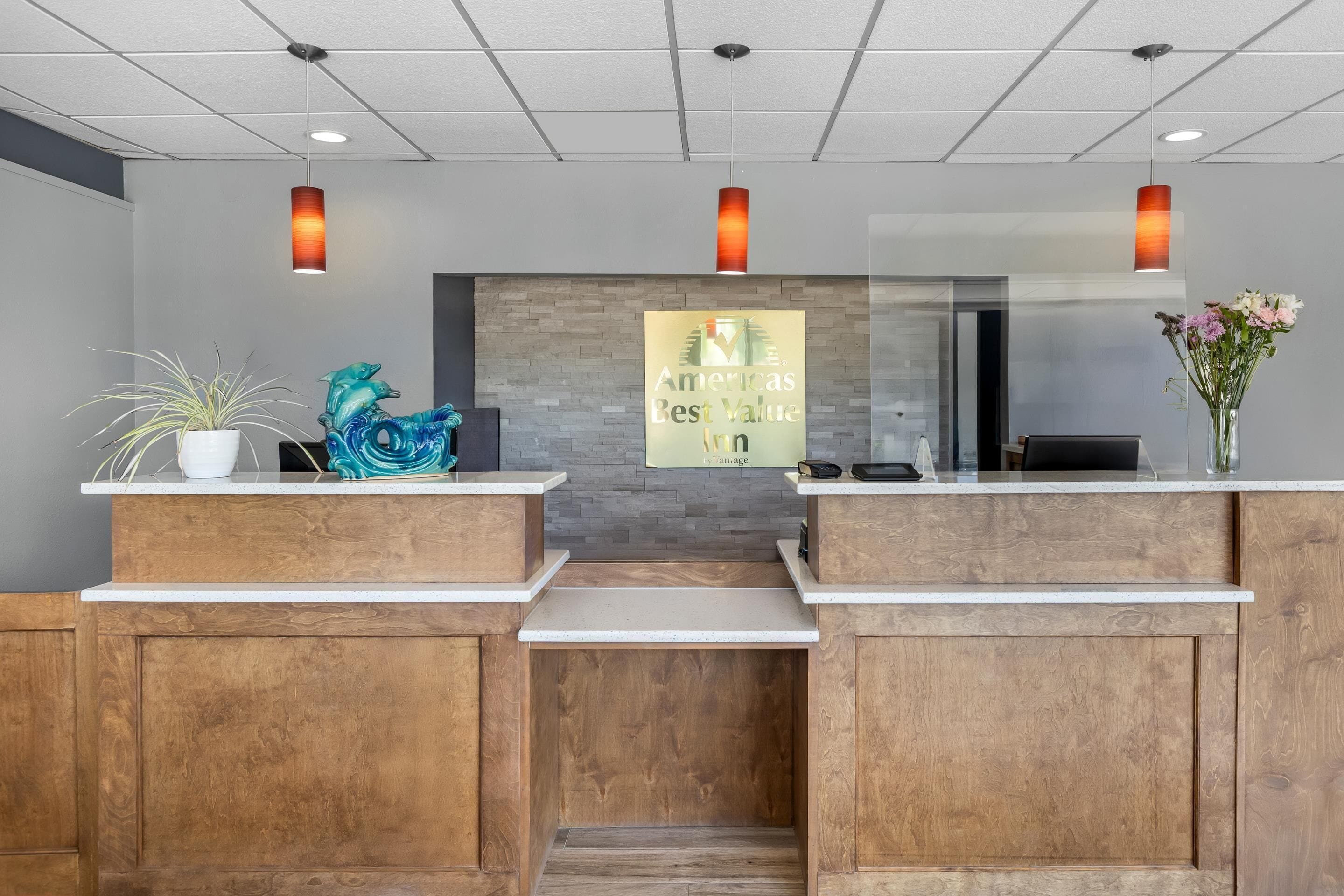 A reception desk with a sign reading 'America's Best Value Inn by Vantage'.