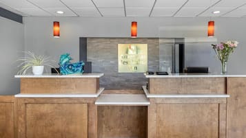 A reception desk with a sign reading 'America's Best Value Inn by Vantage'.