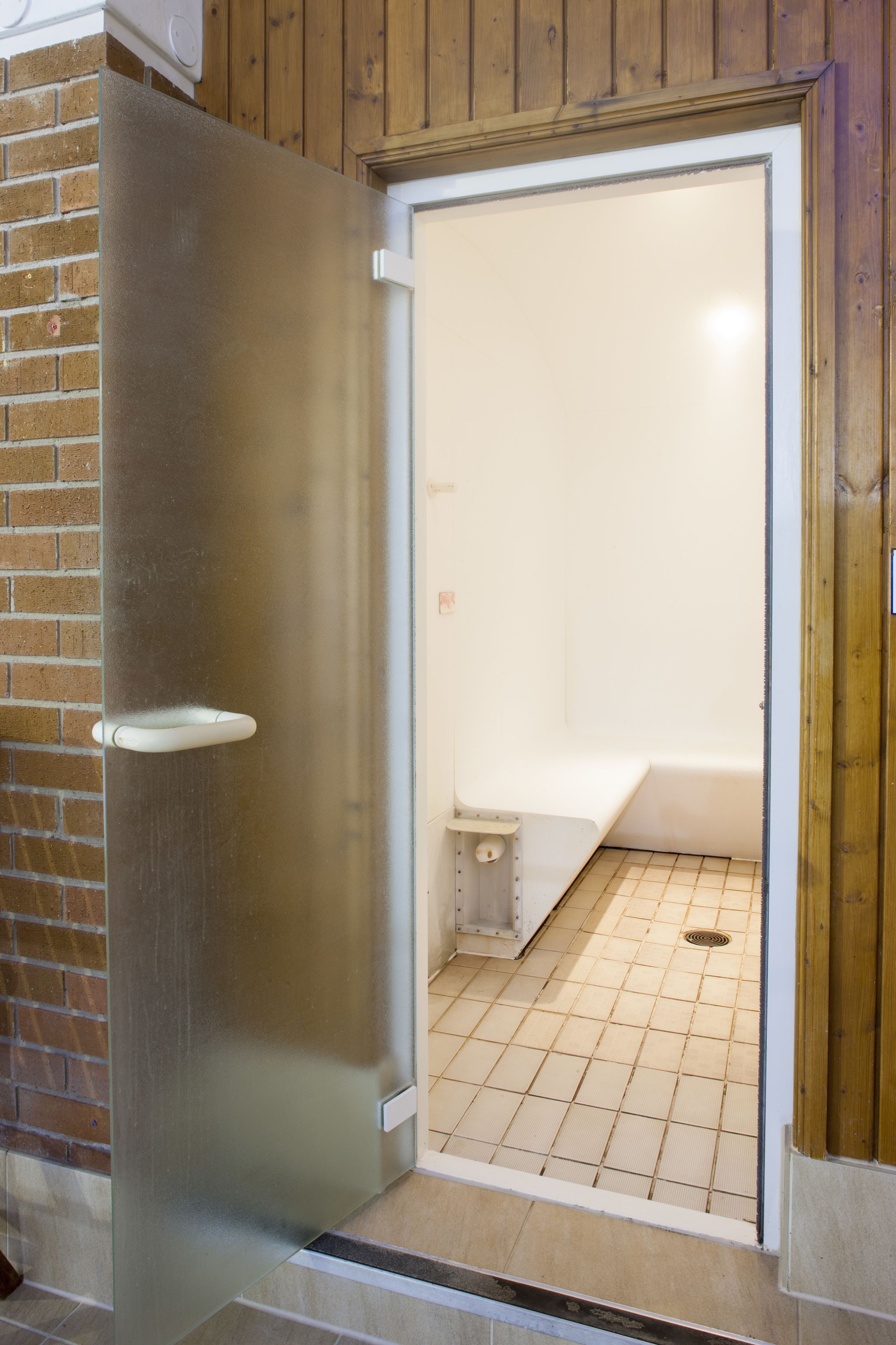 A bathroom with a shower, a toilet, and a sink.