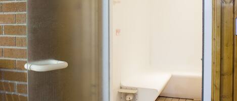 A bathroom with a shower, a toilet, and a sink.