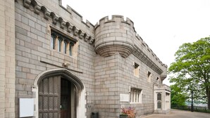 A historic building with a large arched entrance, a turret, and a stone facade. - Holiday Inn Norwich by IHG (Norwich)