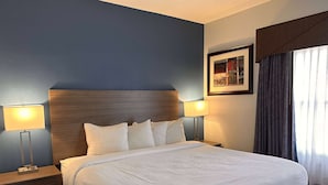 Een net opgemaakt bed met witte lakens in een hotelkamer.