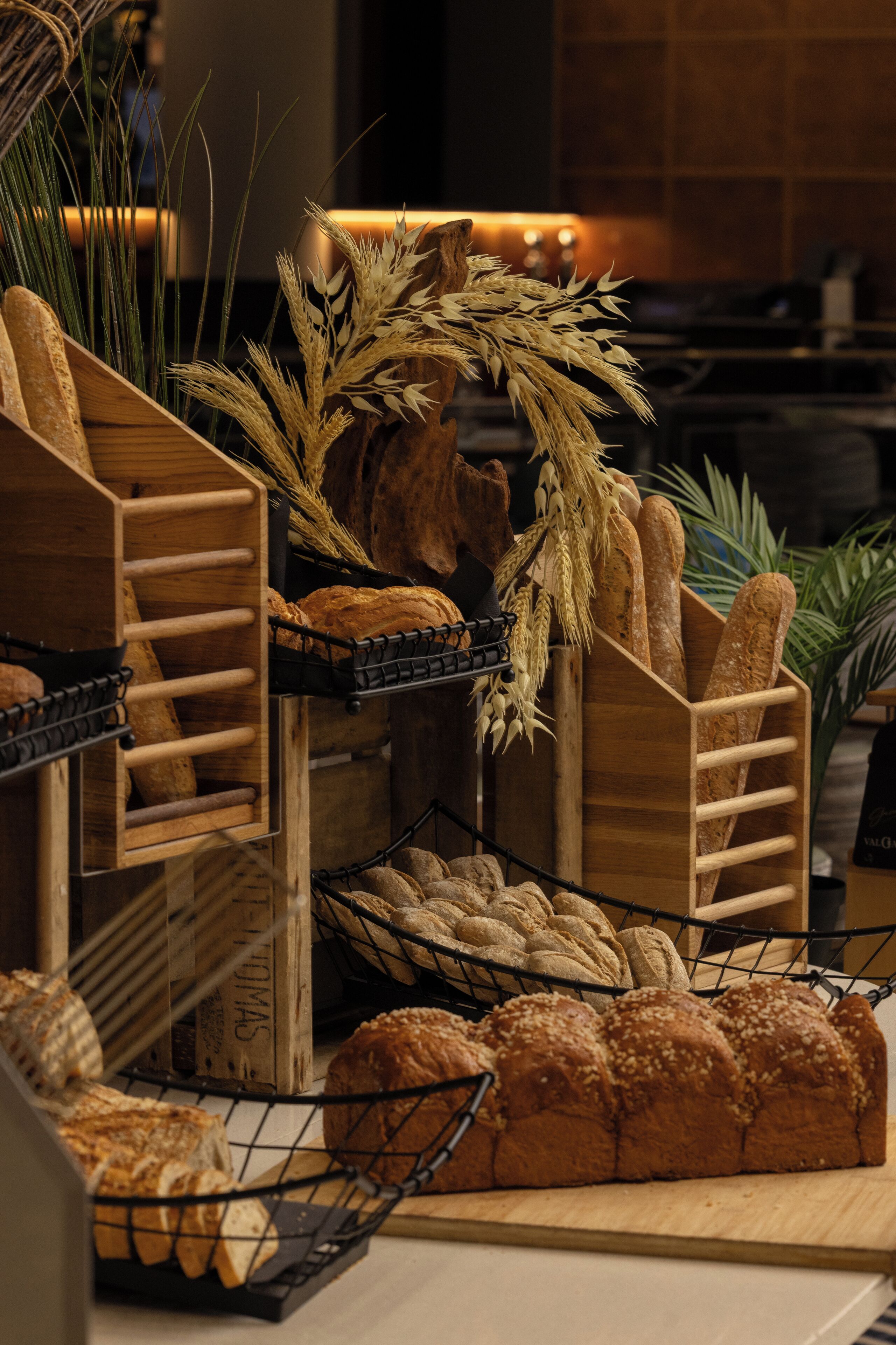 A bakery display with various breads and loaves.