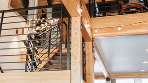 A multi-level wooden interior with a staircase, ceiling fan, and natural light from windows. - Vail Racquet Club Mountain Resort (Vail)