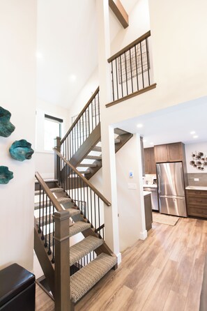 A modern kitchen with a stainless steel refrigerator, wooden cabinets, and a built-in oven. - Vail Racquet Club Mountain Resort (Vail)