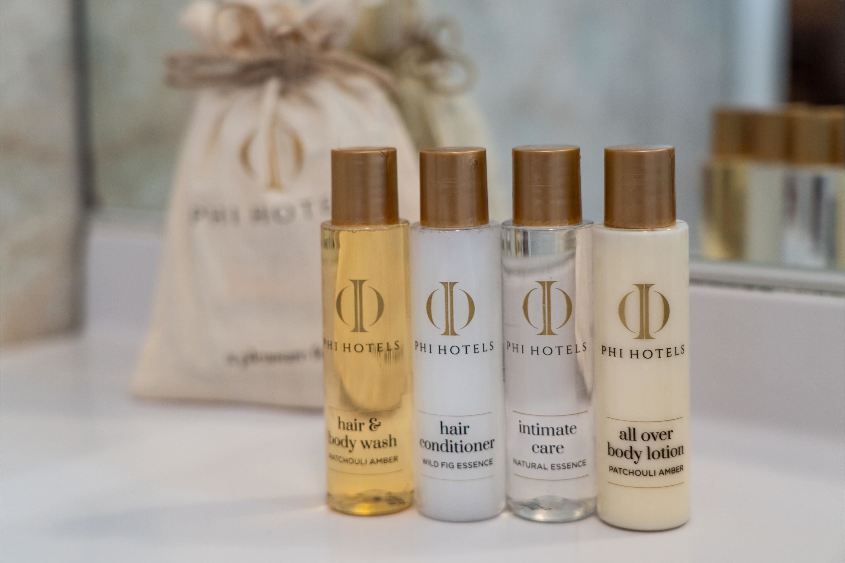 Four bottles of Phi Hotels body care products.