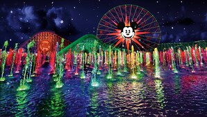A water fountain show with a Ferris wheel and a building with a circular logo in the background. - Holiday Inn Hotel & Suites Anaheim by IHG (Anaheim)