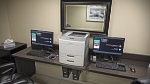 A hotel reception desk with two computer monitors, a printer, and a telephone. - Holiday Inn Hotel & Suites Anaheim by IHG (Anaheim)