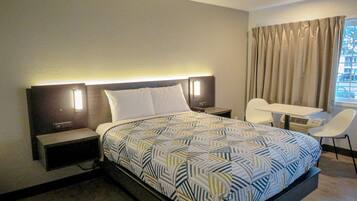 Desk, laptop workspace, blackout drapes, iron/ironing board