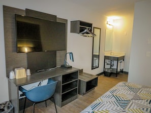 Desk, laptop workspace, blackout drapes, iron/ironing board