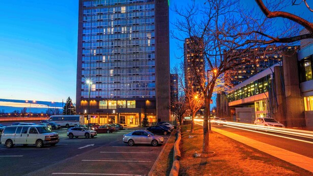 A tall hotel building with a visible sign reading "Sandman."