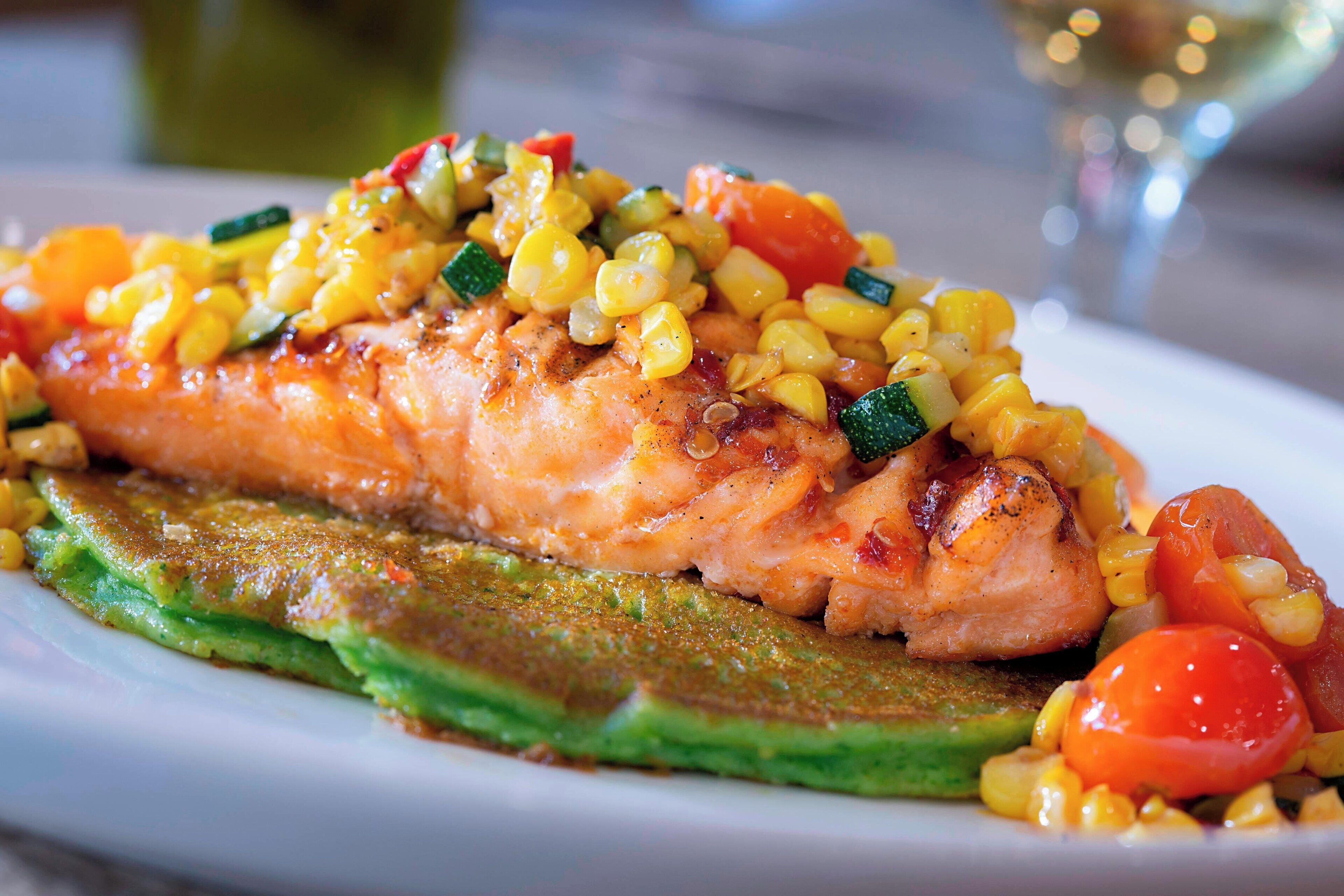 A plate of grilled salmon with vegetables.